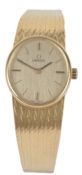A lady's 18kct gold Omega manual wind bracelet wrist watch, the oval dial with baton numerals,
