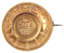 A Victorian gold roundel brooch, mid 19th century, of Archaeological inspiration, depicting the