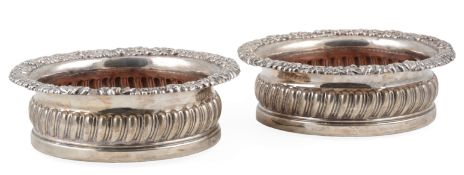 A pair of late George III silver mounted wine coasters, by Thomas & John Settle, with spiral