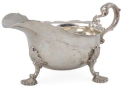 A late Victorian George II style silver sauce boat, by Henry Sratford, with scroll handle, on