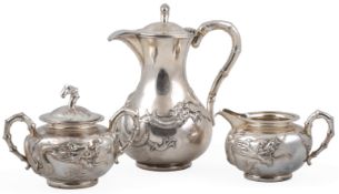A late 19th/early 20th century Chinese three piece white metal tea set by Wang Hing, Hong Kong, of