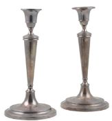 A pair of George III silver candlesticks, by John Parsons & Co, with tapering panelled circular