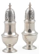 A pair of George II silver pepperettes, by Samuel Wood, of baluster form, with turned finials,