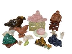 A collection of sixteen Chinese hard stone carvings to include a goldstone Buddha and a malachite