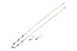 A yellow metal (stamped 375) and six stone oval cut blue topaz set necklace, 56cm and pair of