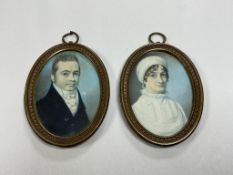 Regency school, a pair of portrait miniatures of a husband and wife, oval watercolours on ivory,
