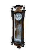 A late 19th century walnut Vienna type wall clock with Roman numeral dial, 110cm high