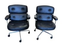 A pair of Eames style swivel desk chairs, width 68cm, depth 60cm, height 92cm