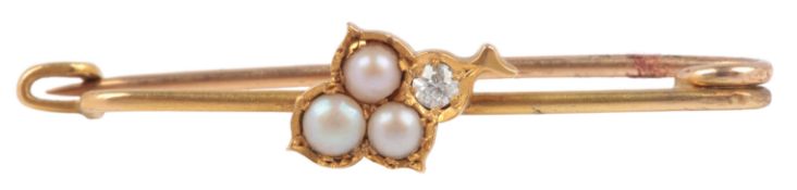 A seed pearl and diamond bar brooch, early 20th century, centring on a leaf motif set with split