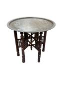 A Benares brass tray top table, diameter 76cm, height 56cm