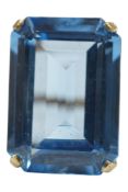 A yellow metal and large single stone emerald cut blue paste set dress ring, stamped 9ct, size Q/