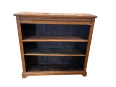 A late Victorian oak open bookcase, width 119cm, depth 31cm, height 112cm