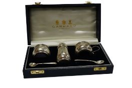 An Elizabeth II silver three piece condiment set, with two spoons and blue glass liners, by