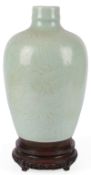 A Chinese carved celadon glazed vase, 19th century,in imitation of a Song dynasty Qingbai vase,