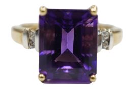 A recent 9ct gold and single stone emerald cut amethyst set ring, with simulated diamond set