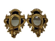 A pair of gilt girandole wall mirrors, each with twin candle holders and blue glass panels, height