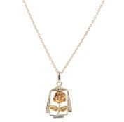 An unmarked two colour yellow metal 'Rose' pendant, overall 18mm, on a gilt 925 chain.