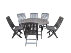 A circular teak garden table, diameter 130cm, height 75cm and six similar chairs