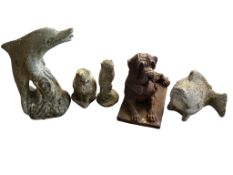 A cast iron recumbent hound garden ornament, a dolphin garden water feature and four other stone