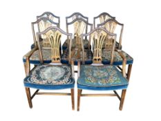 A set of eight Hepplewhite style mahogany dining chairs, each with differing floral upholstered tape