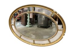 An early 20th century giltwood oval marginal plate wall mirror, width 113cm, height 84cm