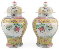 A pair of Chinese yellow ground famille rose jars and covers, Jiaqing - Daoguang period, early