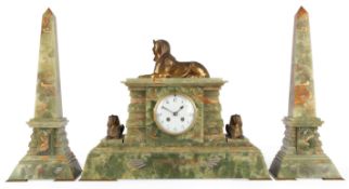 A French gilt bronze and onyx Egyptian revival clock garniture, early 20th century,the white