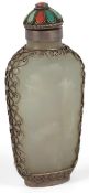 A Chinese pale grey jade silver, coral and turquoise mounted snuff bottle, in Tibetan style, early