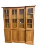 A modern light oak inverted breakfront bookcase, constructed from timber fallen during the 1987