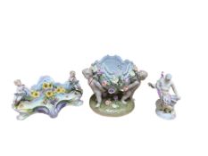 Two German floral encrusted porcelain centrepieces and a porcelain figure, largest 17cm high (3)
