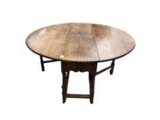 An early 18th century oak dropleaf gateleg table, width 145cm extended, depth 135cm, height 71cm
