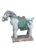 A Chinese part glazed pottery model of a horse, probably Ming dynasty, 26cm high