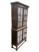 A 1920's carved oak bookcase, width 96cm, depth 35cm, height 198cm