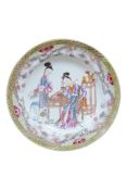 A Chinese famille rose plate enamelled with a calligraphy student at a table, diameter 22cm.