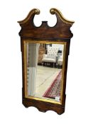 A George III style parcel gilt mahogany wall mirror, width 49cm, height 100cm