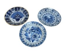 Three 18th century Dutch Delft blue and white chargers, largest 35cm diameter