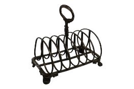 A William IV silver seven bar toast rack, on shell and scroll feet, Henry Wilkinson & Co, Sheffield,