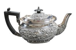 An Edwardian repousse silver teapot, embossed with scrolls, by William Henry Leather, Birmingham,