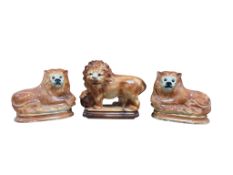 A pair of late Victorian Staffordshire lions and one other