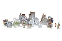A collection of Staffordshire groups to include two pocket watch stands, largest 36cm high (16)