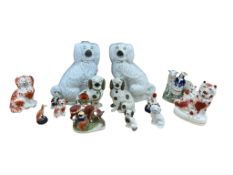 A collection of eleven Victorian Staffordshire pottery dogs, and other Victorian Staffordshire
