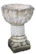 A reconstituted stone font bowl, in a 12th century Norman style, of circular form with a deep basin,