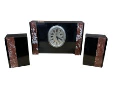 An Art Deco black slate and marble three piece clock garniture, clock 21cm high.