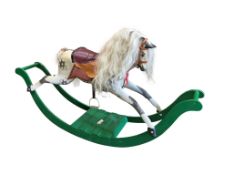 An early 20th century dapple grey rocking horse, length 170cm, depth 35cm, height 95cm