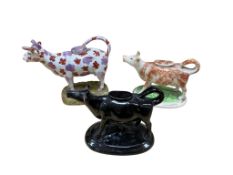 Three 19th century Staffordshire cow creamers