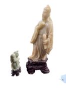A Chinese soapstone carving of a scholar and another, smaller figure, largest 25cm high (2)
