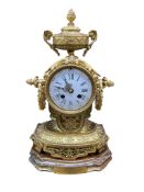 A 19th century French ormolu mantel clock, with urn surmount on wood plinth base