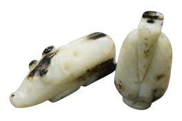 Two Chinese archaistic black and white jade carvings, largest 7.5cm wide