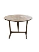 A 19th century French oak vendange table, diameter 88cm, height 71cm