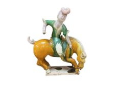 A Chinese Sancai glazed equestrian figure group, Tang style, 28cm high